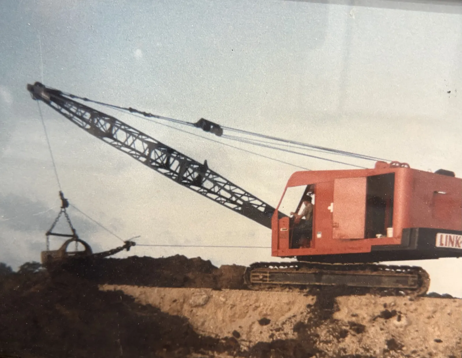 An early red Link-Belt crawler crane and operator on a Randy Kinder Excavating job