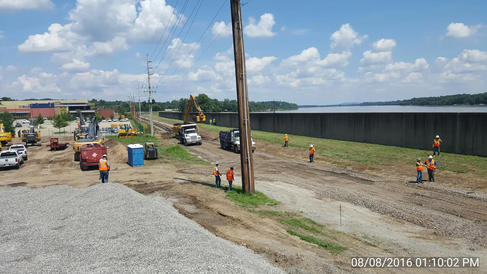 Aerial view of an active RKE floodwall job site along the river