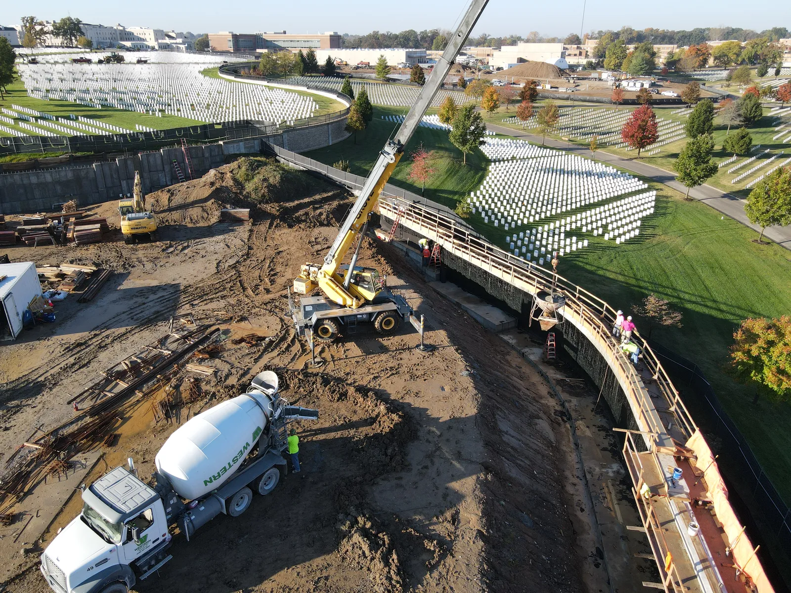 Aerial view of an RKE crane and concrete crews on a federal cemetery project