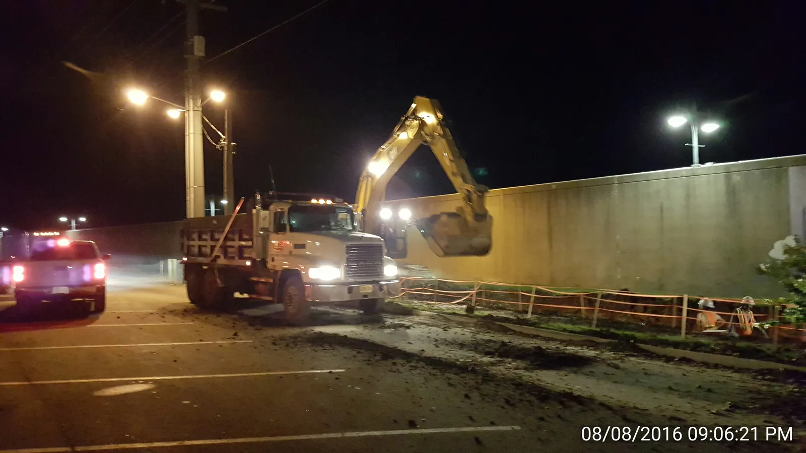 RKE night excavation crew working under lights at a floodwall site